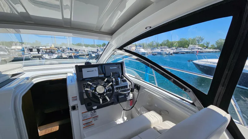  Yacht Photos Pics 2017 Cruisers Yachts 390 Express Coupe helm with marina view.