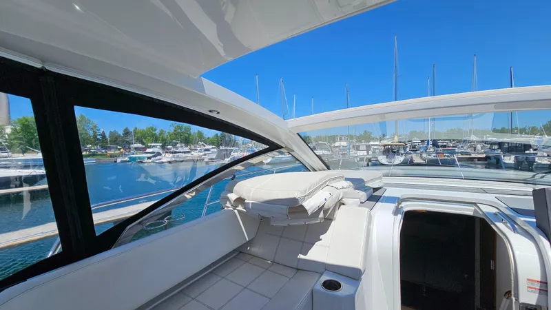  Yacht Photos Pics 2017 Cruisers Yachts 390 Express Coupe interior with marina view, featuring sleek design and comfort.