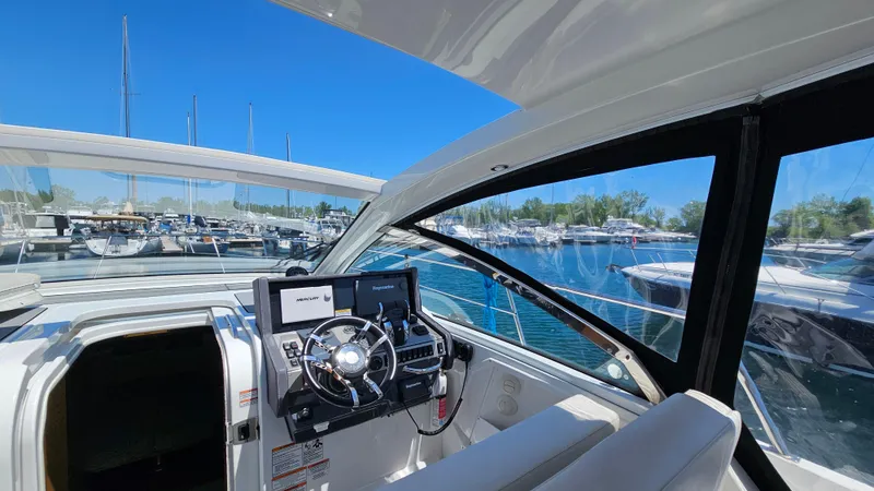  Yacht Photos Pics 2017 Cruisers Yachts 390 Express Coupe helm with marina view.