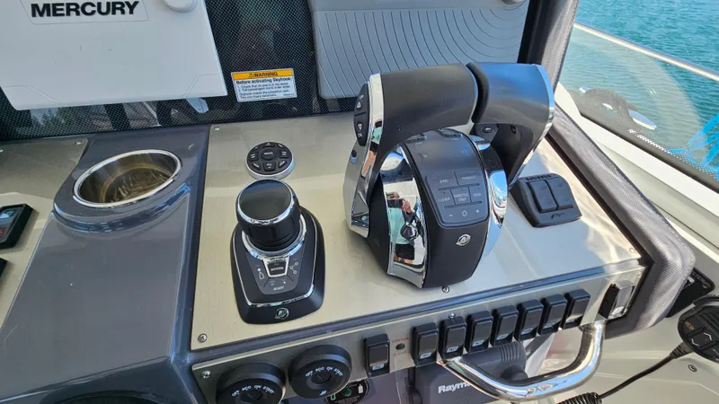  Yacht Photos Pics Control panel of 2017 Cruisers Yachts 390 Express Coupe with Mercury throttle and joystick.