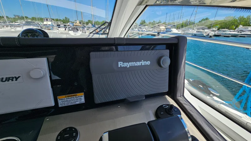  Yacht Photos Pics Control panel of 2017 Cruisers Yachts 390 Express Coupe with Raymarine equipment, docked at marina.