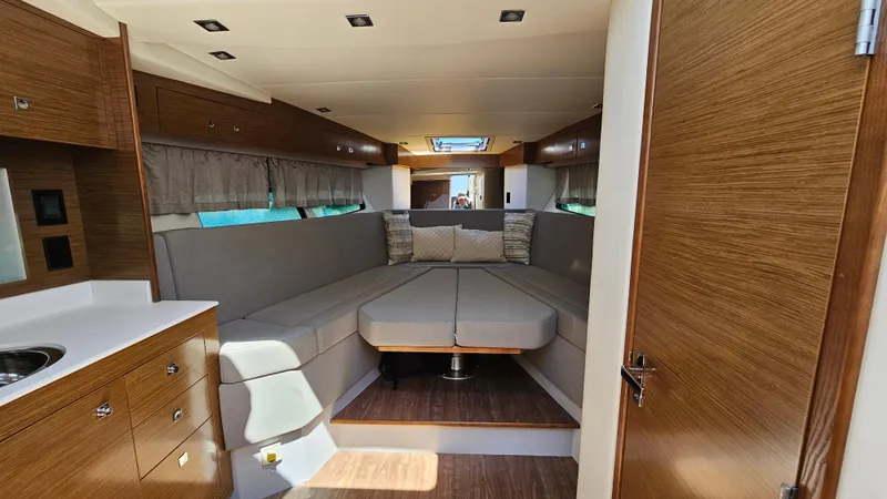  Yacht Photos Pics 2017 Cruisers Yachts 390 Express Coupe interior with modern wood finish and cozy seating.