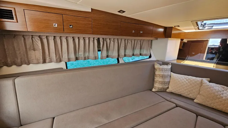  Yacht Photos Pics Interior of 2017 Cruisers Yachts 390 Express Coupe with beige seating and wooden cabinets.