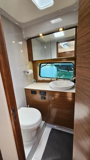  Yacht Photos Pics 2017 Cruisers Yachts 390 Express Coupe bathroom with modern fixtures and wood accents.