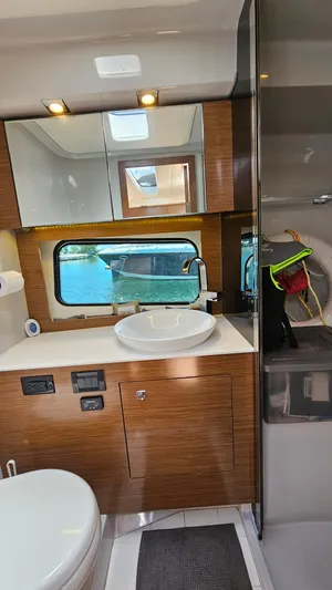  Yacht Photos Pics 2017 Cruisers Yachts 390 Express Coupe bathroom with modern fixtures and wood cabinetry.