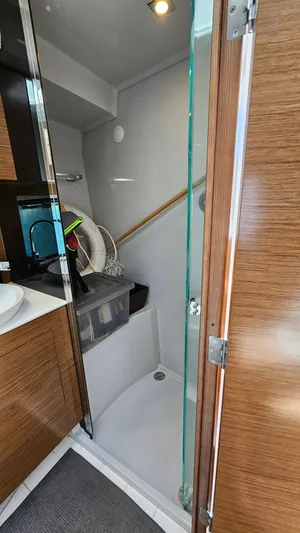  Yacht Photos Pics 2017 Cruisers Yachts 390 Express Coupe bathroom with modern fixtures and wooden accents.