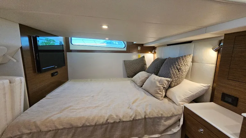  Yacht Photos Pics Luxurious cabin interior of 2017 Cruisers Yachts 390 Express Coupe with cozy bed and modern decor.