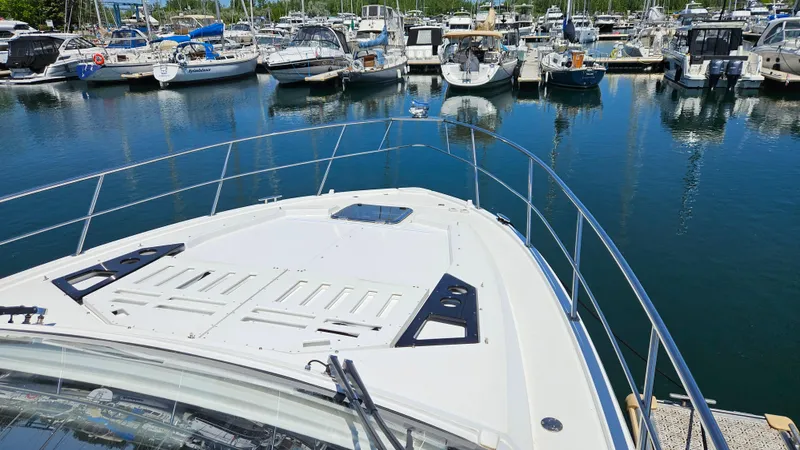  Yacht Photos Pics 2017 Cruisers Yachts 390 Express Coupe docked in a marina, surrounded by boats.