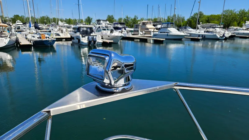  Yacht Photos Pics 2017 Cruisers Yachts 390 Express Coupe at marina, chrome detail, calm water, sunny day.
