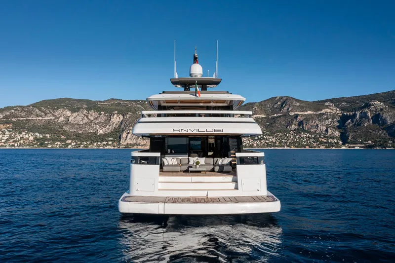 X96 Triplex Yacht Photos Pics Luxury yacht Extra X96 TRIPLEX 2025 on serene blue waters with scenic mountain backdrop.