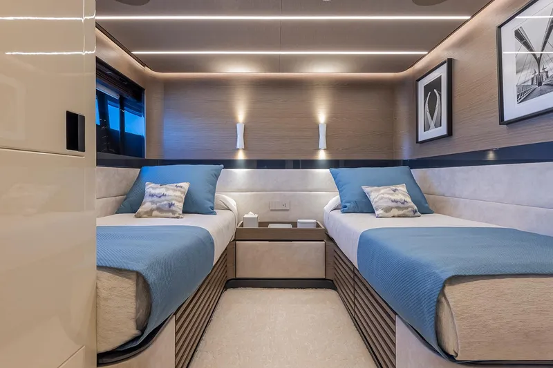 X96 Triplex Yacht Photos Pics Modern twin bedroom in Extra X96 TRIPLEX yacht, 2025 model, with blue bedding and sleek design.