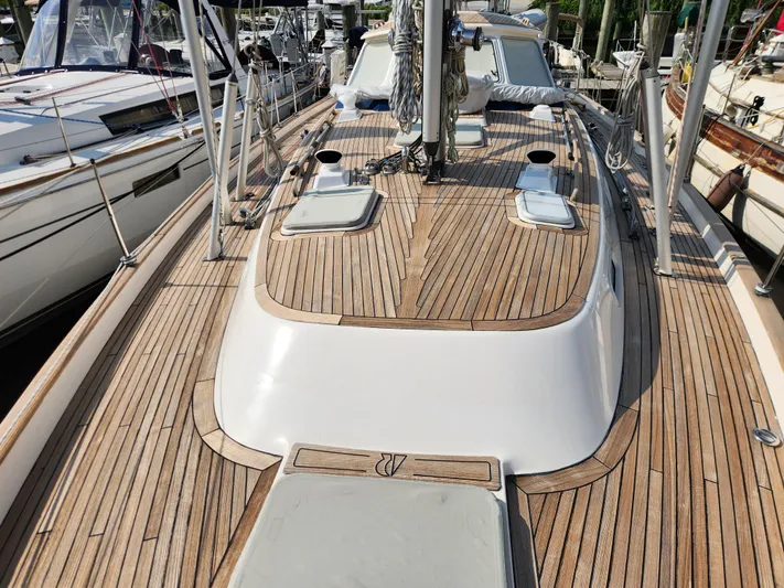 Bella Rose Yacht Photos Pics Deck view of a 2006 Hallberg-Rassy 48 sailboat with teak wood finish.