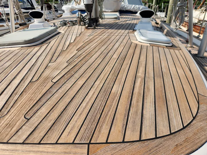 Bella Rose Yacht Photos Pics Teak deck of 2006 Hallberg-Rassy 48 sailboat, showcasing elegant wood craftsmanship.