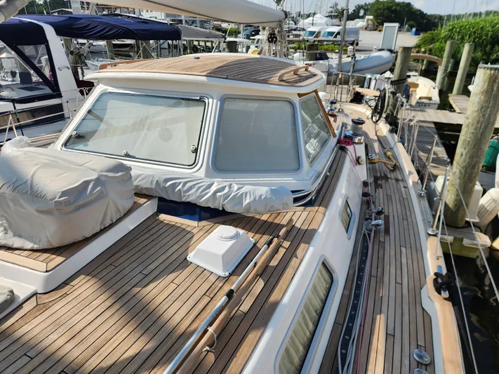 Bella Rose Yacht Photos Pics 2006 Hallberg-Rassy 48 sailboat with teak deck, docked at a marina.