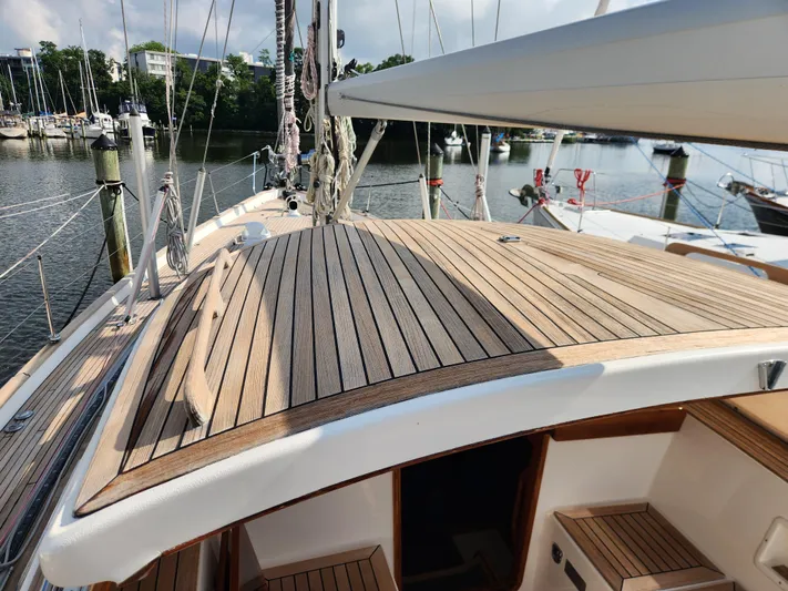 Bella Rose Yacht Photos Pics 2006 Hallberg-Rassy 48 sailboat with teak deck, docked in a marina.