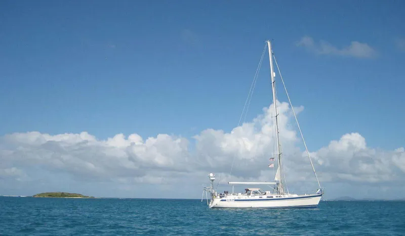 Bella Rose Yacht Photos Pics Sailing yacht Hallberg-Rassy 48 (2006) on calm blue sea under clear sky.