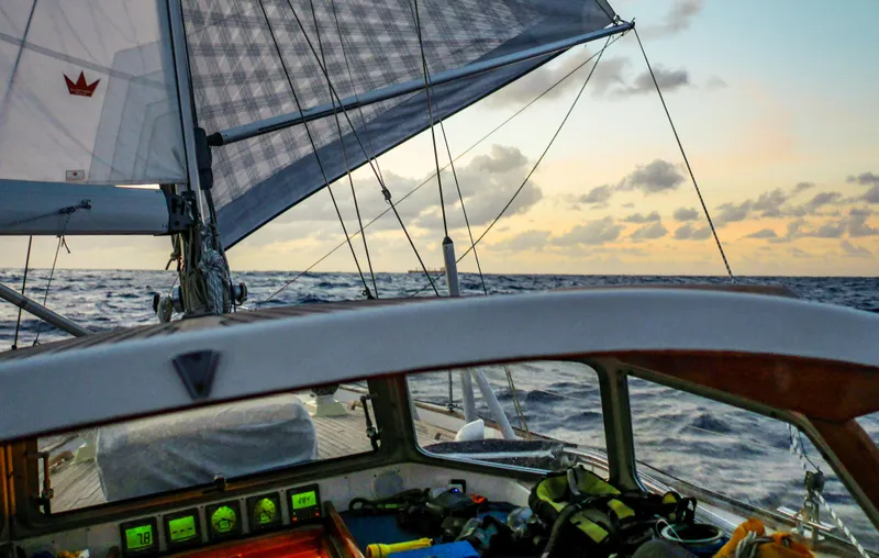 Bella Rose Yacht Photos Pics Sailing on a 2006 Hallberg-Rassy 48 yacht at sunset, open ocean view.