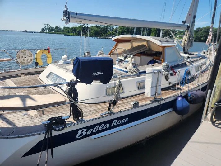 Bella Rose Yacht Photos Pics 2006 Hallberg-Rassy 48 sailboat "Bella Rose" docked by the water on a sunny day.