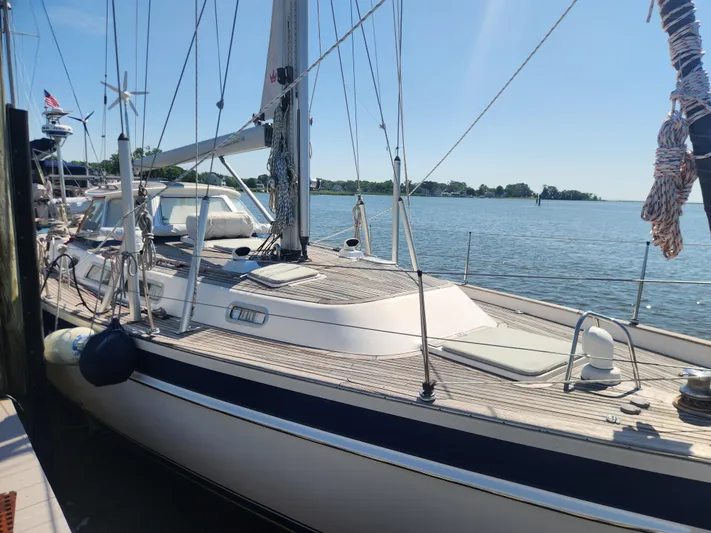 Bella Rose Yacht Photos Pics Sailing yacht Hallberg-Rassy 48, 2006 model, docked by the water on a sunny day.