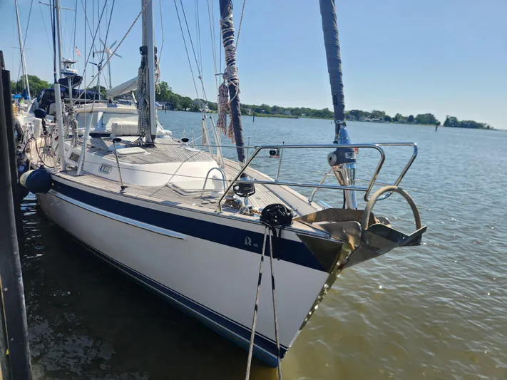 Bella Rose Yacht Photos Pics 2006 Hallberg-Rassy 48 sailboat docked on a sunny day, showcasing sleek design and craftsmanship.