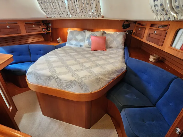 Bella Rose Yacht Photos Pics Luxurious 2006 Hallberg-Rassy 48 yacht cabin with cozy bed and blue seating.