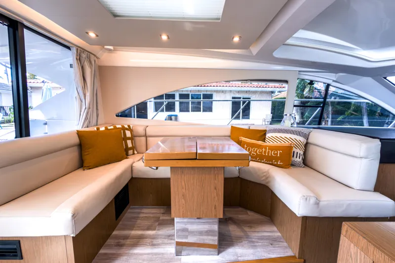  Yacht Photos Pics Luxurious interior of 2015 Beneteau Gran Turismo 49 yacht with elegant seating and cushions.