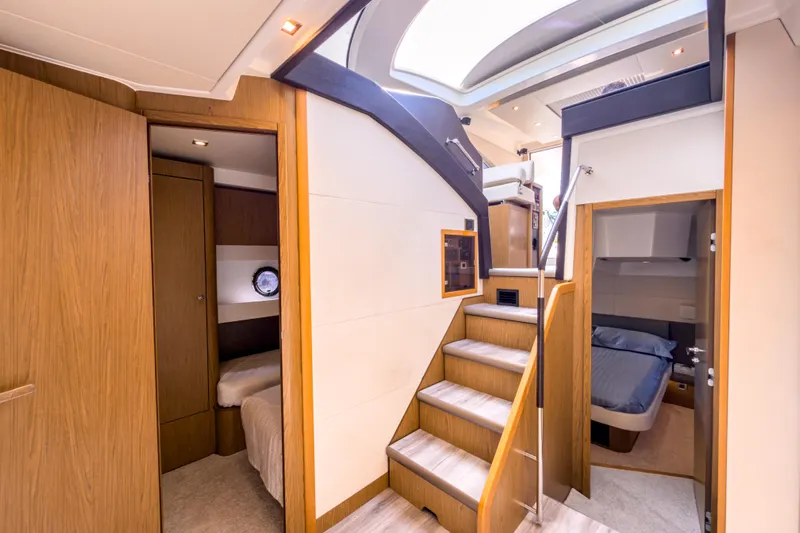  Yacht Photos Pics Luxurious interior of 2015 Beneteau Gran Turismo 49 yacht with wooden finishes and cozy cabins.
