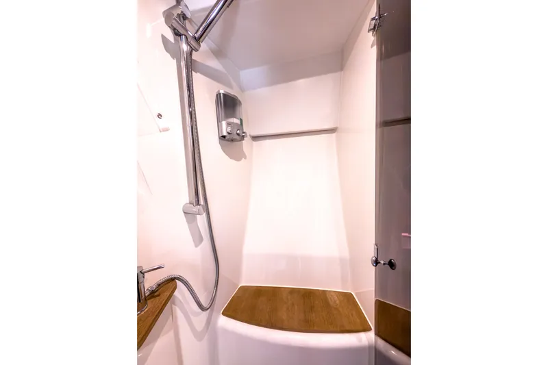  Yacht Photos Pics Shower area in 2015 Beneteau Gran Turismo 49 yacht, featuring modern fixtures and wooden accents.