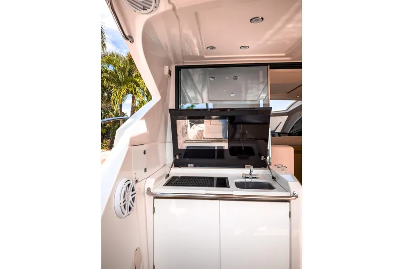  Yacht Photos Pics Outdoor kitchenette on a 2015 Beneteau Gran Turismo 49 yacht, featuring a sink and grill.