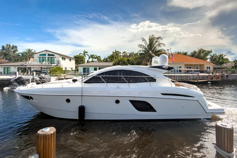  Yacht Photos Pics 2015 Beneteau Gran Turismo 49 yacht docked in a scenic waterfront setting.