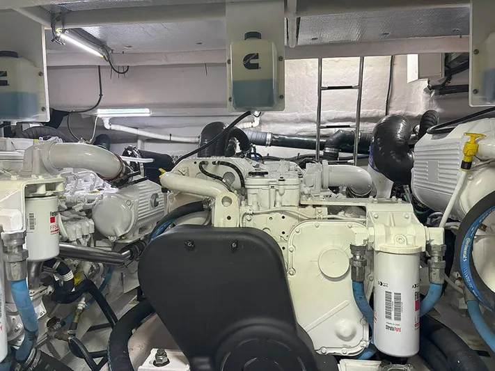  Yacht Photos Pics Engine room of a 2017 Sea Ray L590 yacht, showcasing mechanical components and piping.