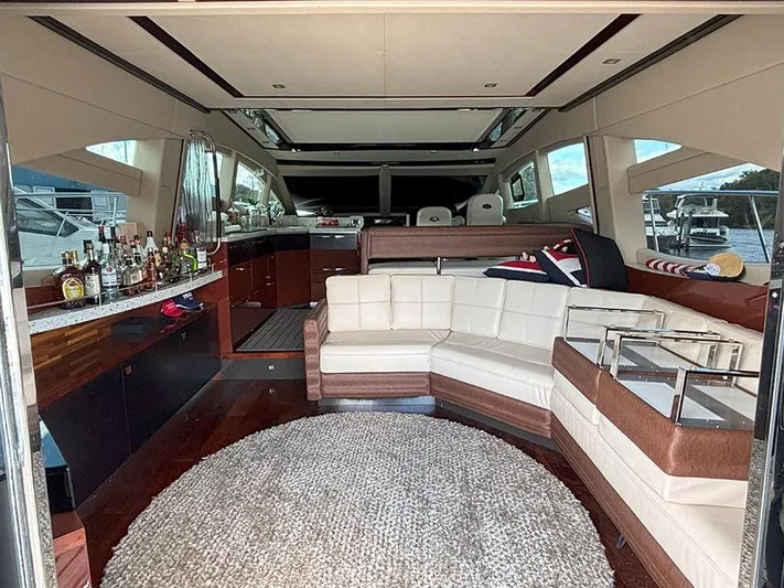  Yacht Photos Pics Luxurious interior of 2017 Sea Ray L590 yacht with plush seating and bar area.