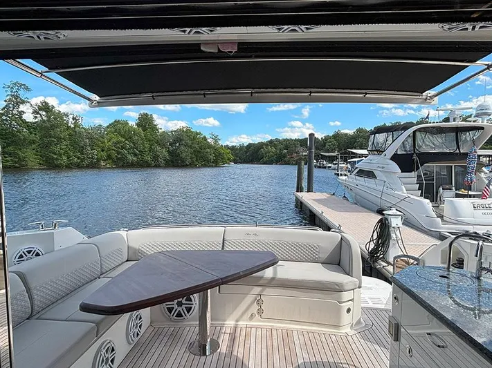  Yacht Photos Pics 2017 Sea Ray L590 yacht deck with seating, table, and scenic waterfront view.