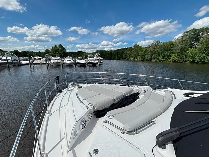  Yacht Photos Pics 2017 Sea Ray L590 yacht docked on a serene lake under a clear blue sky.