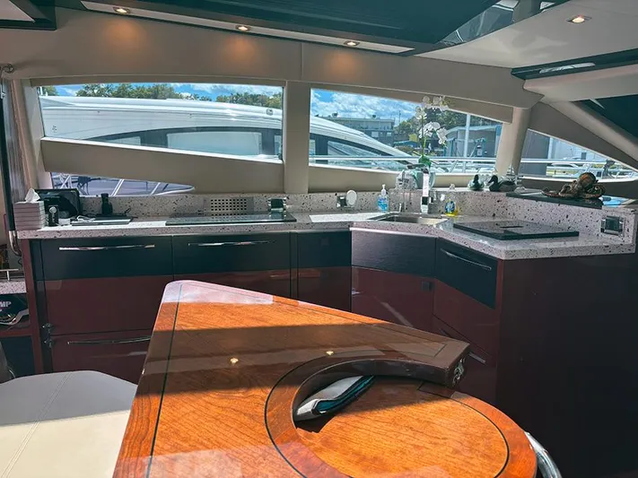  Yacht Photos Pics Luxurious interior of 2017 Sea Ray L590 yacht with modern kitchen and elegant wood finishes.