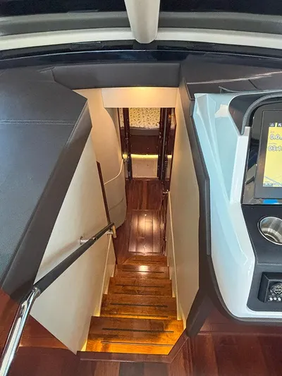  Yacht Photos Pics Interior view of 2017 Sea Ray L590 yacht, featuring polished wooden stairs and modern design.