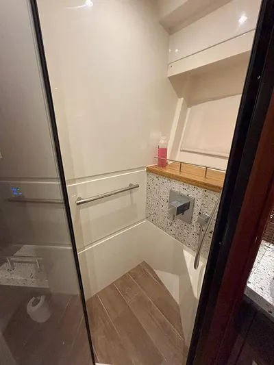  Yacht Photos Pics Shower area in 2017 Sea Ray L590 yacht with modern fixtures and wooden accents.