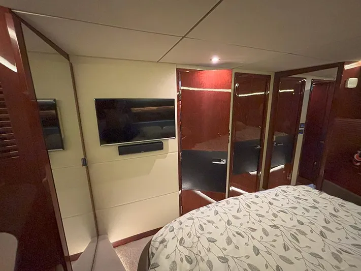  Yacht Photos Pics Luxurious interior of 2017 Sea Ray L590 yacht with TV and elegant wood finishes.