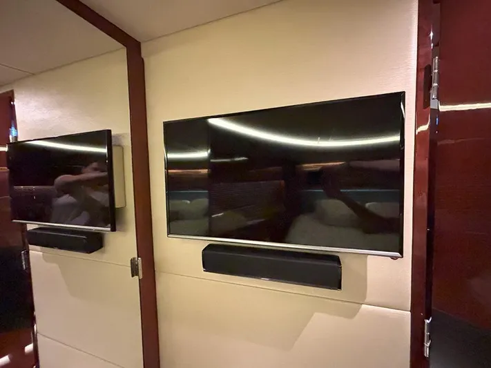  Yacht Photos Pics Flat-screen TVs inside 2017 Sea Ray L590 yacht interior, featuring modern design and wood accents.