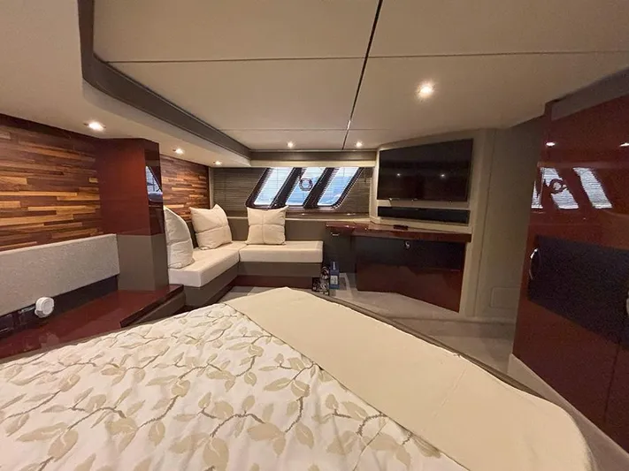  Yacht Photos Pics Luxurious interior of 2017 Sea Ray L590 yacht with elegant wood paneling and cozy seating.