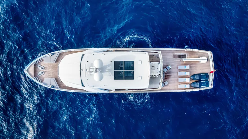 Evelyn P Yacht Photos Pics Aerial view of 2022 Numarine 37XP yacht cruising on deep blue ocean waters.