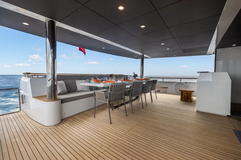 Evelyn P Yacht Photos Pics Luxurious 2022 Numarine 37XP yacht deck with elegant dining setup and ocean view.