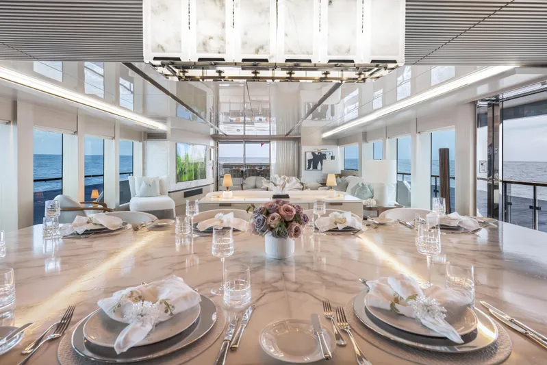 Evelyn P Yacht Photos Pics Luxurious dining area on 2022 Numarine 37XP yacht with elegant table setting and ocean view.