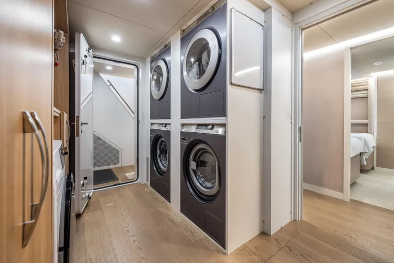 Evelyn P Yacht Photos Pics Laundry room on 2022 Numarine 37XP yacht with stacked washers and dryers.