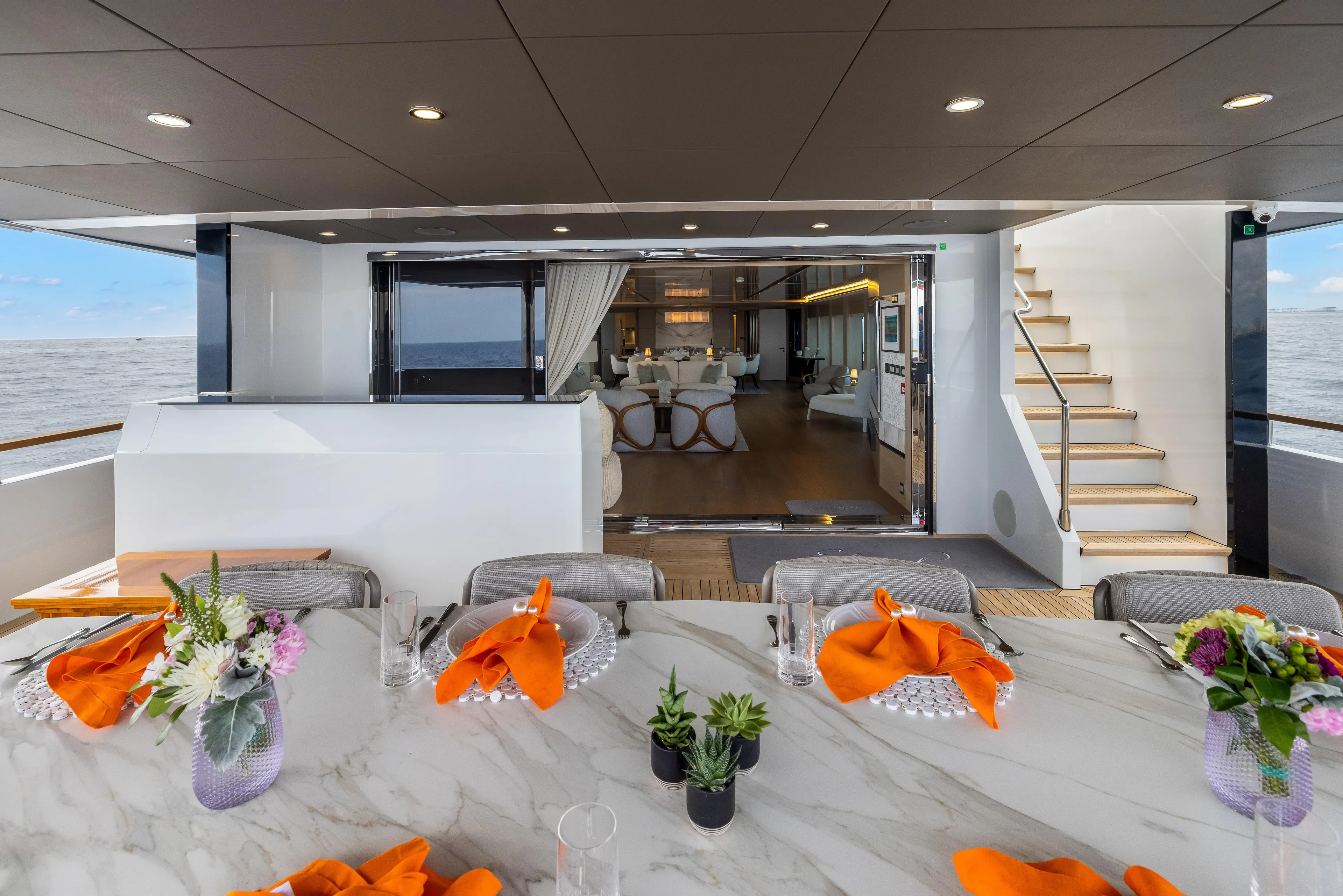 Evelyn P Yacht Photos Pics Luxurious 2022 Numarine 37XP yacht interior with elegant dining setup and ocean view.