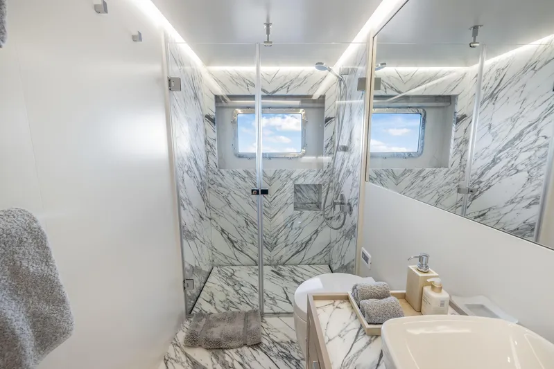 Evelyn P Yacht Photos Pics Luxurious marble bathroom in 2022 Numarine 37XP yacht with modern fixtures and ocean view.