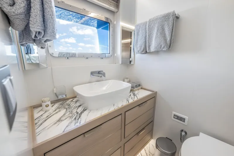 Evelyn P Yacht Photos Pics Luxurious bathroom on 2022 Numarine 37XP yacht with marble countertop and ocean view.