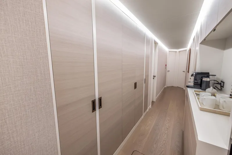 Evelyn P Yacht Photos Pics Luxurious interior hallway of 2022 Numarine 37XP yacht with modern cabinetry and coffee station.