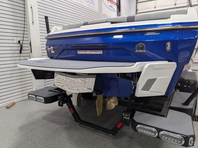 2025 Axis A225 boat rear view with swim platform and propeller.