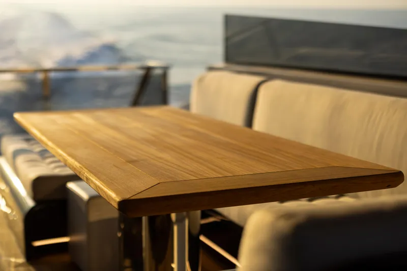  Yacht Photos Pics Luxurious seating area on 2025 MandaYachts 07 SPIDER with wooden table.